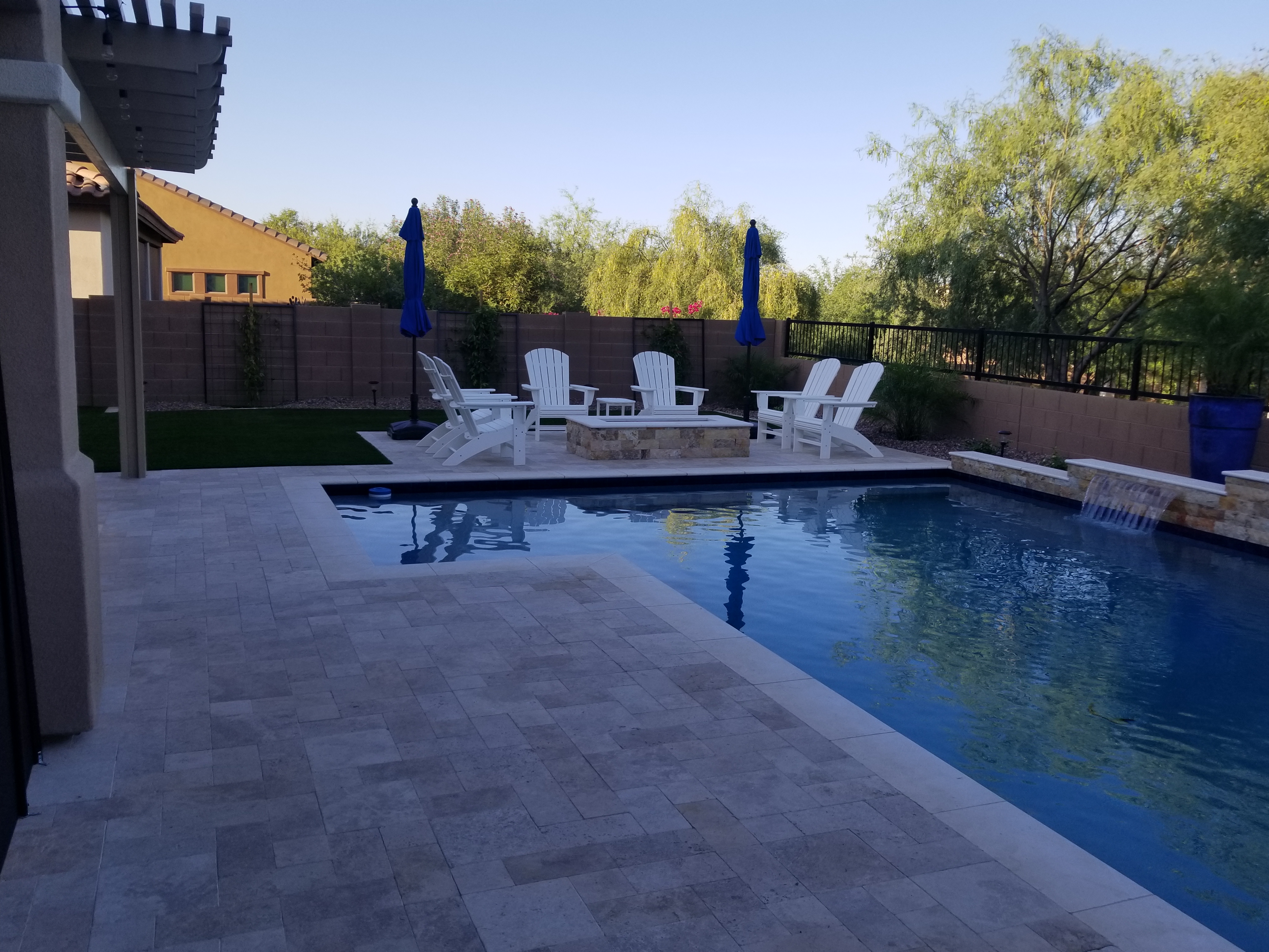 Pool remodel with travertine deck, fire pit and water feature by DCM Pools — Arizona