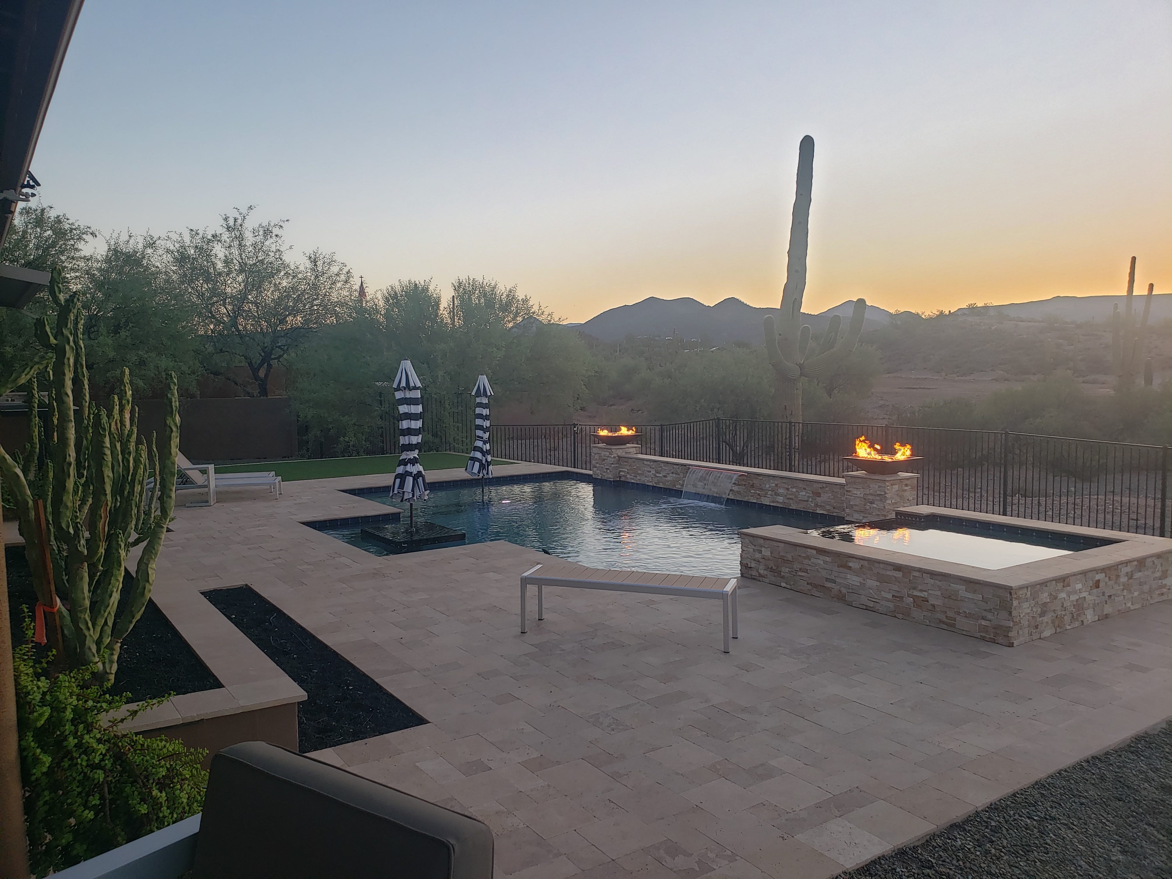 Fire pit with blue glass at poolside by DCM Pools — Arizona