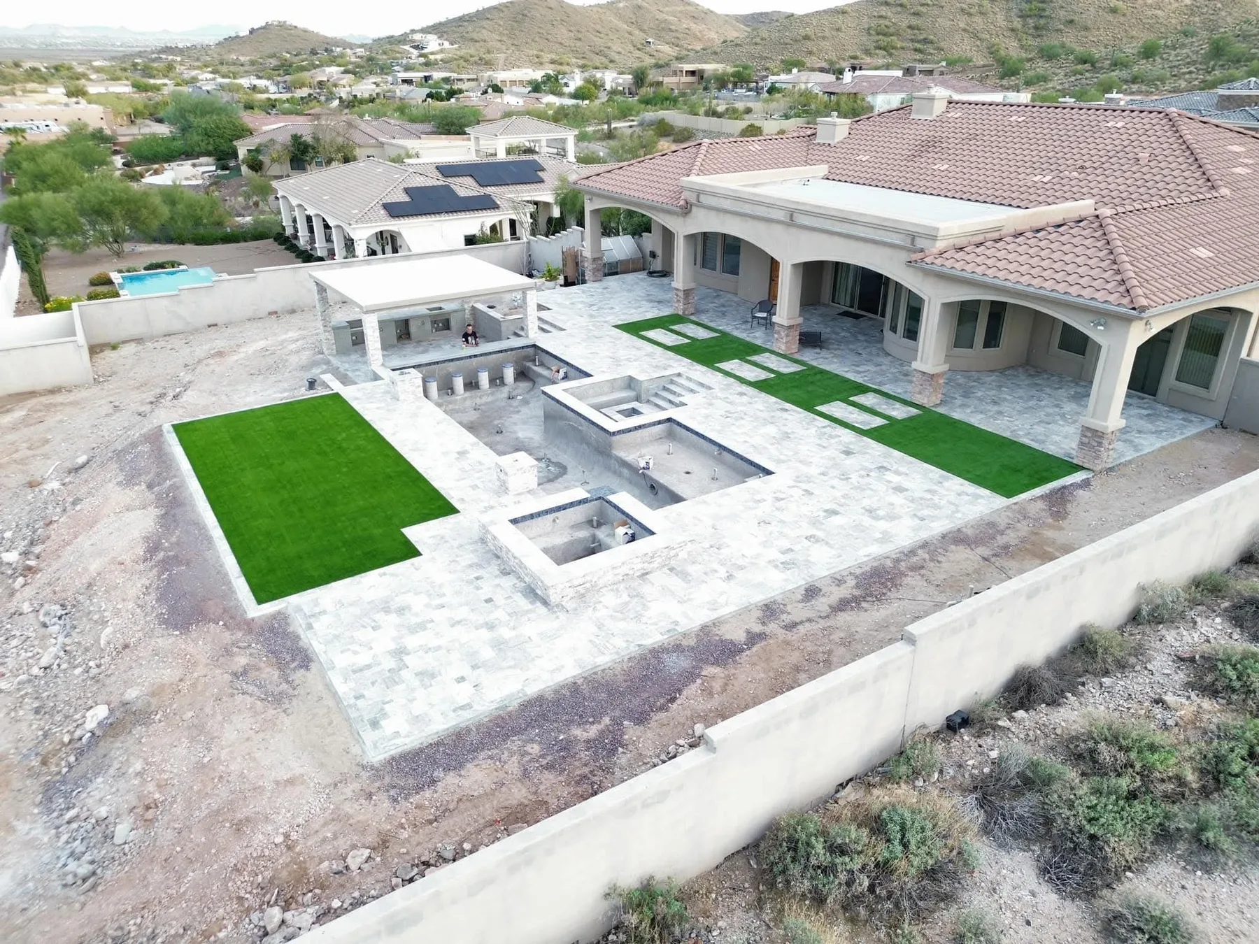 Custom new pool construction by DCM Pools — geometric pool with travertine deck, Arizona