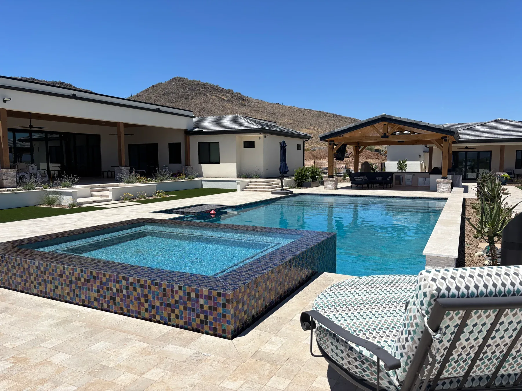 Pool remodeling by DCM Pools — pool and spa with evening lighting, Arizona