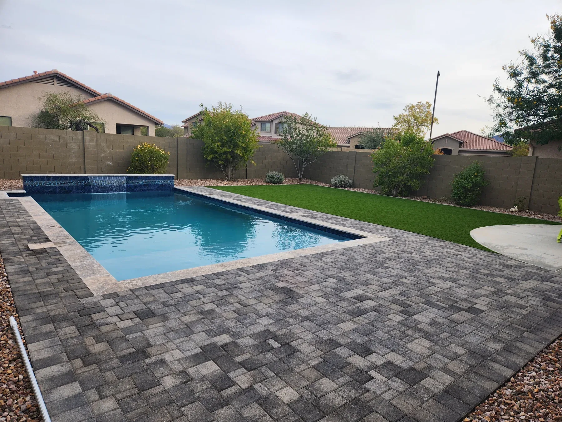 Paver and hardscape installation by DCM Pools — travertine pool deck, Arizona