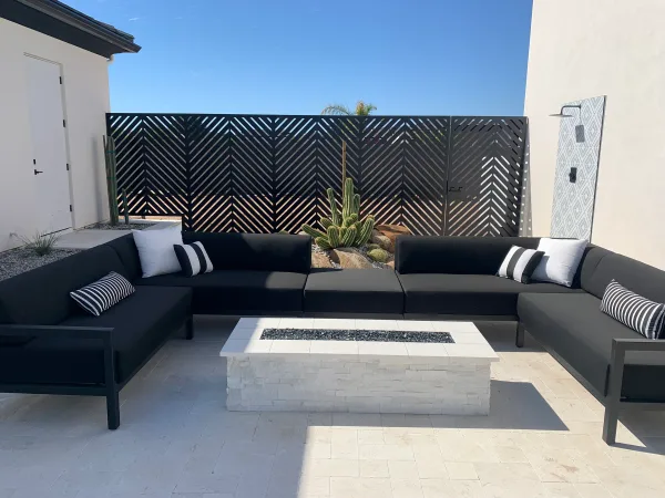 Outdoor lounge area with fire pit by DCM Pools — Arizona