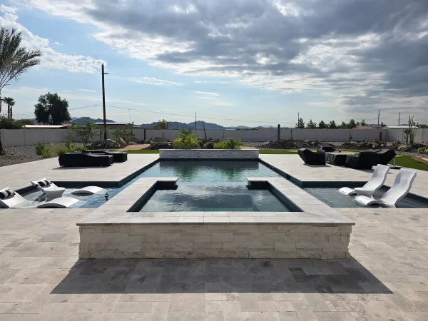 Baja shelf pool with spa and fire feature by DCM Pools — Arizona
