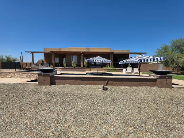Raised retaining wall at pool edge by DCM Pools — Arizona