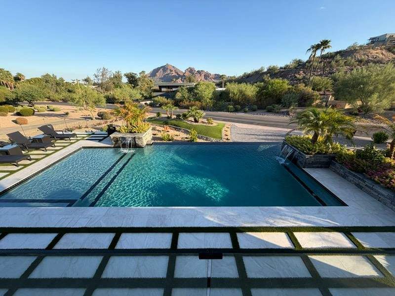 Custom pool design by DCM Pools — pool with travertine deck, fire pit and water features, Arizona